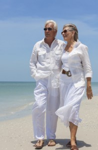 Happy Senior Couple Walking by Sea on Tropical Beach